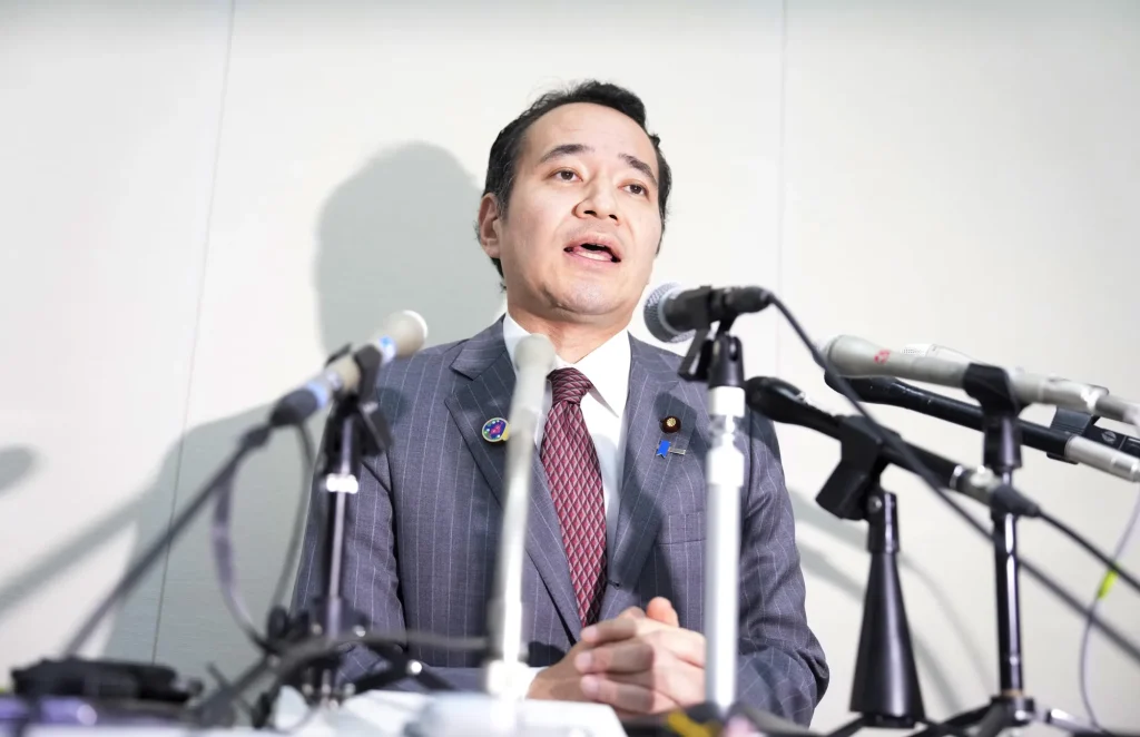 Japanese official speaking at a press conference