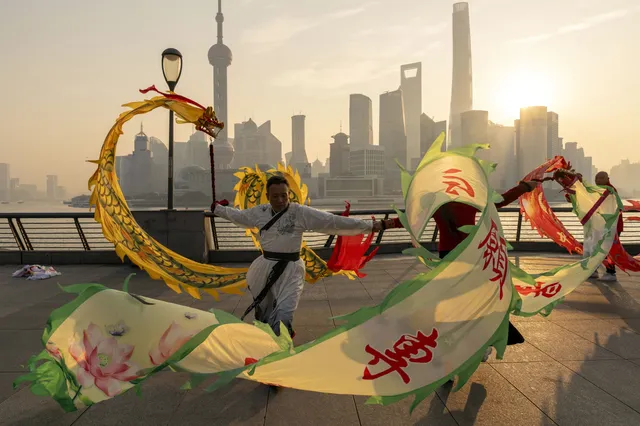 Dragon dance performance in front of the Shanghai skyline
